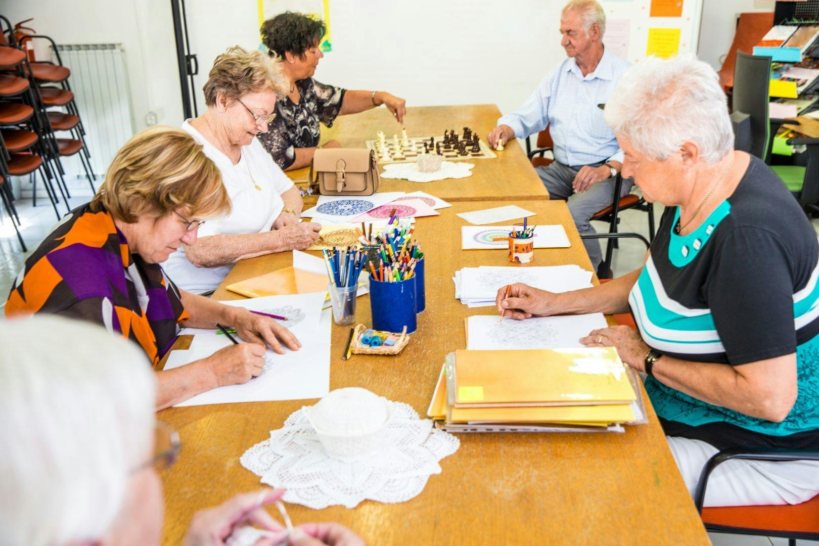 A group of seniors doing craft at a table